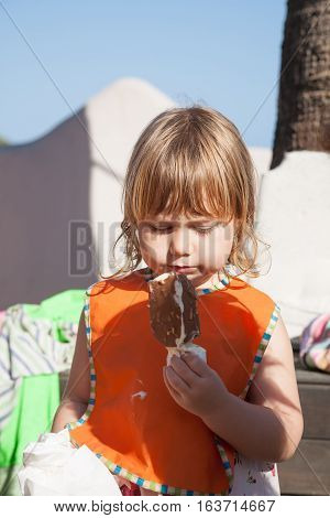 Child With Ice Cream And Orange Bib