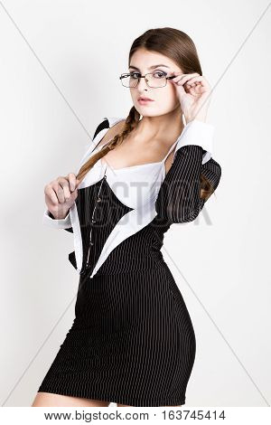 sexy secretary, portrait of beautiful brunette business lady with glasses and wearing in pinstripe suit.