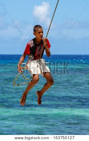 Lavena, Fiji - November 27: Unidentified Boy Swings On A Rope Swing On November 27, 2013 In Lavena V
