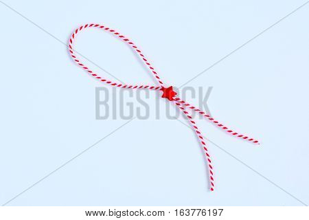 holiday Bulgarian Martenitsa spring sign red and white brasles on white background