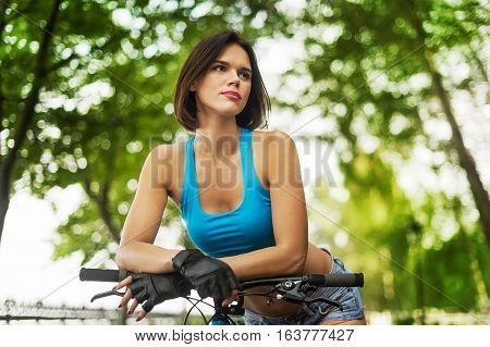 beautiful girl with bike resting before the trip