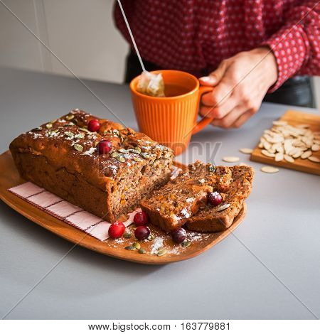 Sliced Home-made Loaf Of Pumpkin Bread, Woman's Hands And Tea