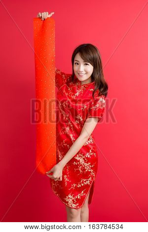 beauty woman wear cheongsam and show couplets with chinese new year