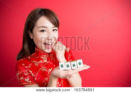 beauty woman wear cheongsam and show mahjong to you in chinese new year