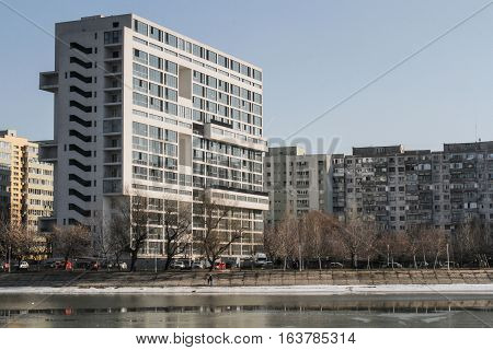 Bucharest Romania : Landscape with tall residential blocks and lake in a Bucharest suburb.