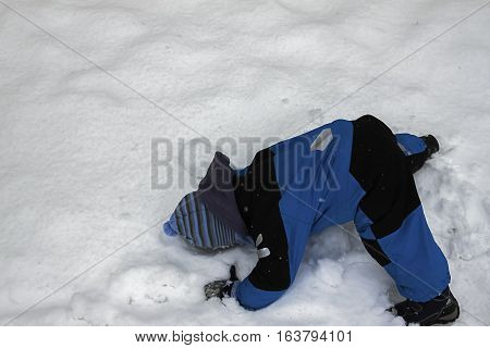 As he was trying to reach for the snow he fell on his head