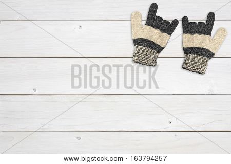 winter brown knitting wool glove one pair for hand protection and i love you symbol on top view white vintage wood table or floor background for valentine day on winter with copyspace