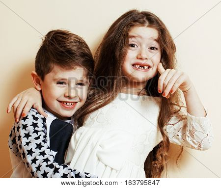 little cute boy and girl hugging playing on white background, happy family smiling brother and sister fooling around