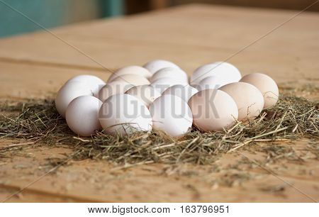 High quality tasty and healthy chicken eggs from domestic hens on wooden mat