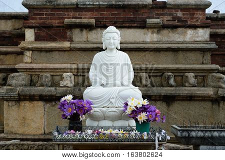 Marble Buddha's statue at entering Mirisavatiya Dagoba in the complex of Anuradhapura ruins ruin historical capital city of the Sinhalese Buddhist state on Sri Lance.