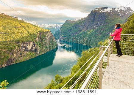 Tourist Looking At Geirangerfjord From Flydasjuvet Viewpoint Norway
