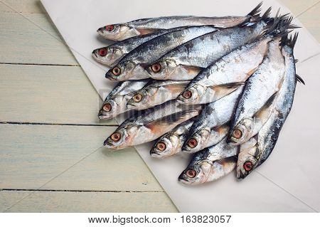 Raw salty sabrefish. Preparation before drying on a rustic wooden table