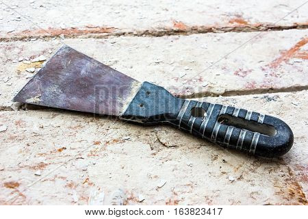 Used putty knife on old dirty building materials boards