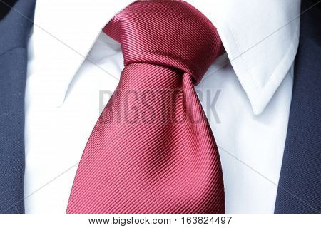 official dress code - classic blue suit, red tie knot, white shirt, closeup, official wear detail,