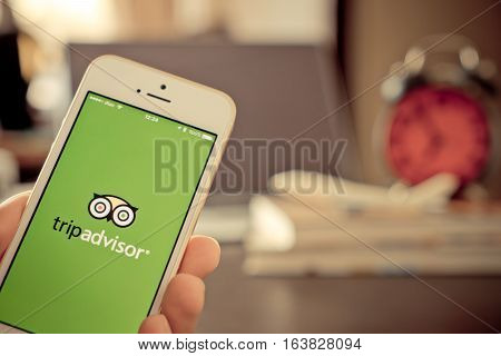 Bangkok, Thailand - December 14, 2016: Business man is using tripadvisor application to plan his trip.