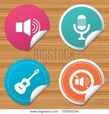Round stickers or website banners. Musical elements icons. Microphone and Sound speaker symbols. No Sound and acoustic guitar signs. Circle badges with bended corner. Vector