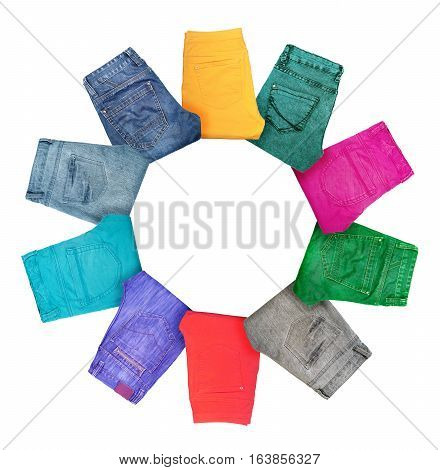 Collection of folded multicolored jeans isolated on white