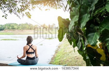 Rear View Close Up Of Woman Perform Meditating Yoga On The Nature Background In The Morning.