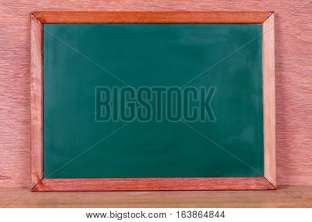 Green school chalkboard with written sentence space