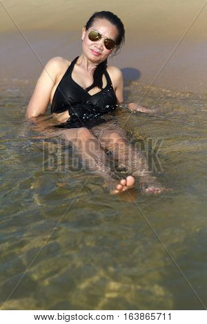 Lady relax body swimsuit in Ban Krut Beach at Prachuap Khirikhun Province Thailand