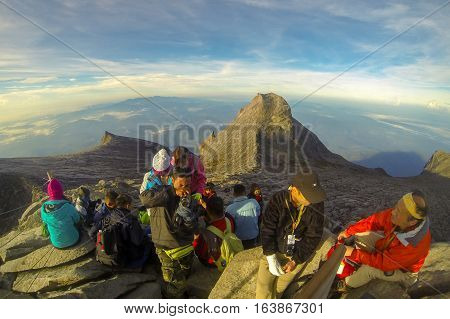 Ranau,Sabah-April 30,2014:Climbers enjoying the view from Low's Peak,4095 meters above sea level of Mount Kinabalu,Sabah.It  is the tallest mountain in Malaysia & the 20th tallest in the World.