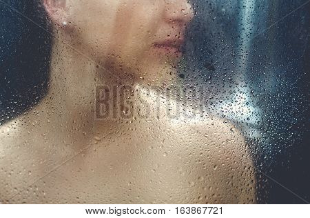 Beautiful sexy  young woman washing body in a shower