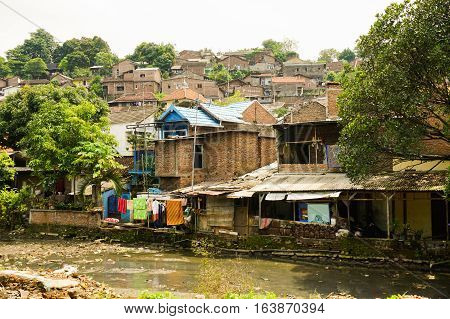 Slums near dirty river photo taken in Semarang Indonesia java