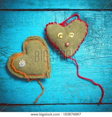 Valentine's Day. Colorful knitted hearts. Red heart on the blue boards. Valentines day. Heart pendant. Red heart. Valentine cards. Space for text. Eighth of March. International Women's Day.