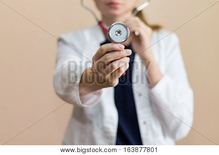Real female doctor with the red stethoscope in medical uniform