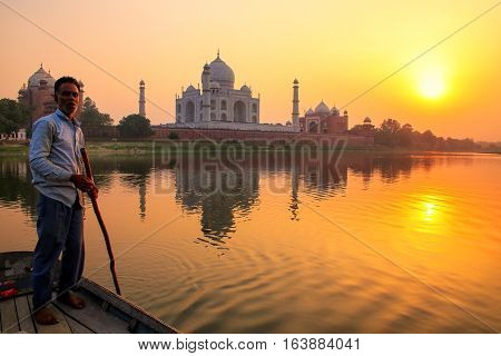 Agra, India - November 8: Unidentified Man Steers Boat On Yamuna River At Sunset In Front Of Taj Mah
