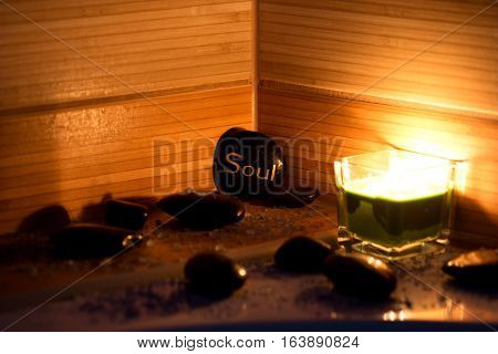 black lava stones massage green candle and bath salt
