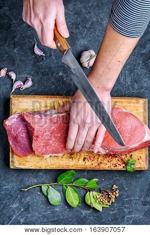 Woman In The Kitchen Is Cutting Beef