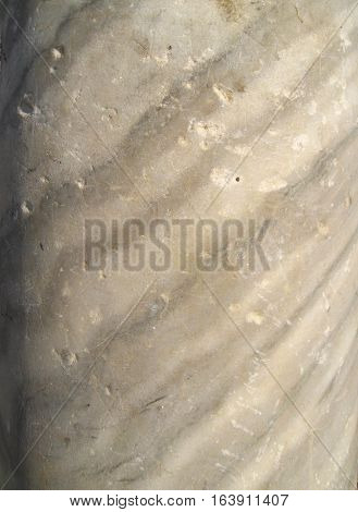 The texture of the old marble to ancient column with diagonal stripes in gray and white.