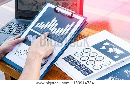 Business Workers Discussing Digital Graphs And Diagrams Indicating Progres.