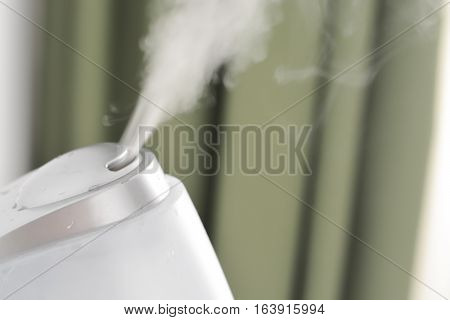 Baby room air humidifier puffing steam indoors