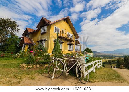 Vintage European style of yellow house in countryside of Mae Hong Son province near Chiang Mai Thailand with Blue sky and clouds.