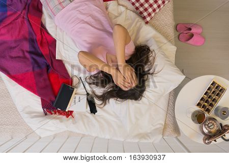 Depressed Woman Lying In Bed