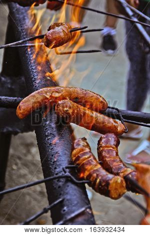 The traditional roast sausage on fire during the manifestations.