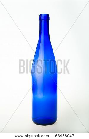 Empty blue wine bottle on white background.