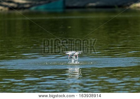 Drowned drone accident. Drone in water.  A drone dramatically crashing into the water