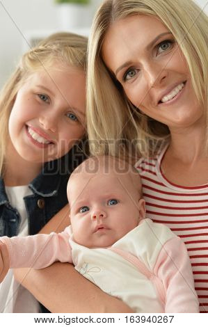 Portrait of a mom with two gaughters, close up
