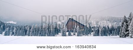Winter in High Tatras Mountains. High Tatry. Slovakia. Vysoke Tatry. Frozen lake winter trees panorama. Lot of snow.