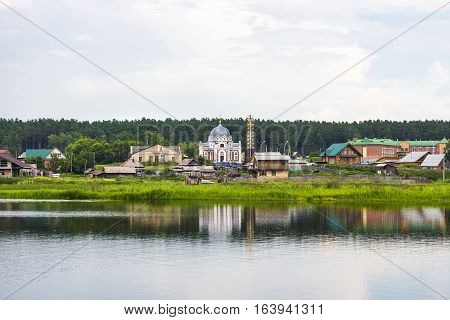 River Karakan the village of Zavyalovo Novosibirsk oblast Siberia Russia - July 7 2016: a view of the ancient Siberian village across the river