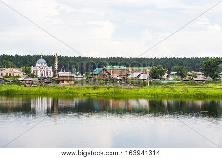River Karakan the village of Zavyalovo Novosibirsk oblast Siberia Russia - July 7 2016: a view of the ancient Siberian village across the river