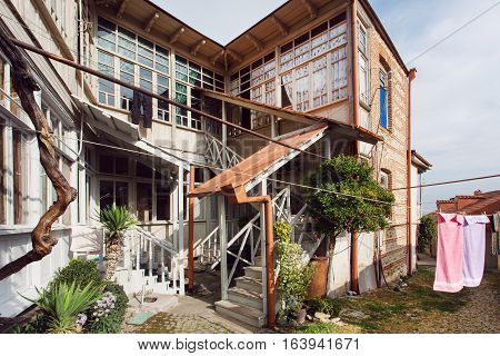 SIGNAGI, GEORGIA - OCT 7, 2016: Simple wooden house with big windows and two floors in rural style on October 7, 2016. Signagi of Kakhetia has a population 2.200