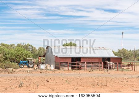 JACOBSDAL SOUTH AFRICA - DECEMBER 24 2016: A farm scene with tractor barn and horse near Jacobsdal a small town in the Free State Province