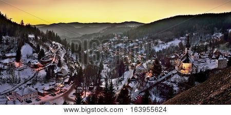 Sunset at winter in Slovakia. Old mining village. Historic church in Spania Dolina.
