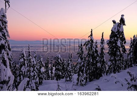 City view at sunset in winter. Grouse Mountain. North Vancouver. British Columbia. Canada.