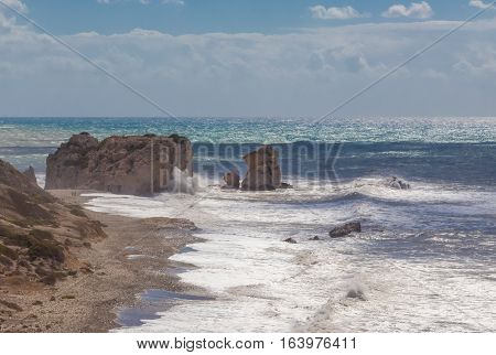 View of Aphrodite's rock at Kouklia Cyprus.  A seascape with a rough sea.  Waves crashing onto the large rocks.