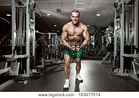Muscular Bodybuilder Guy Doing Exercises Workout In Gym